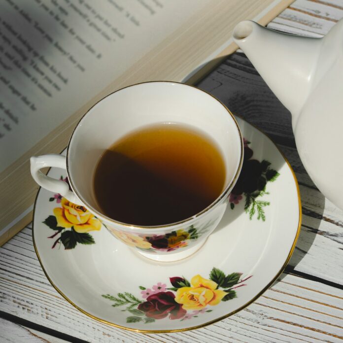 white ceramic teacup on white and pink floral ceramic saucer