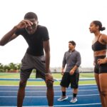 일상 속 ‘작은 움직임’이 대사 건강에 미치는 깊은 영향 Athletes resting on a track after training.