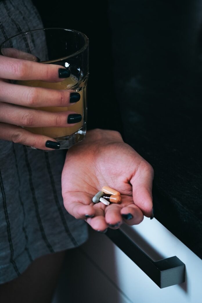 a person holding a glass of beer