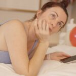 바쁜 일상 속 스트레스, 일상의 작은 변화로 관리하기 Woman lying on bed with phone and balloons