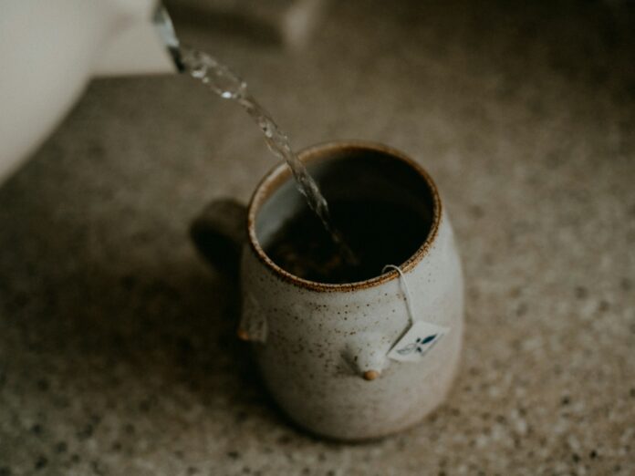Photo by Annie Spratt a cup of coffee is being filled with water