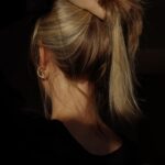 건강한 머릿결, 생활 속 작은 변화가 만든다 a woman with her hair in a bun